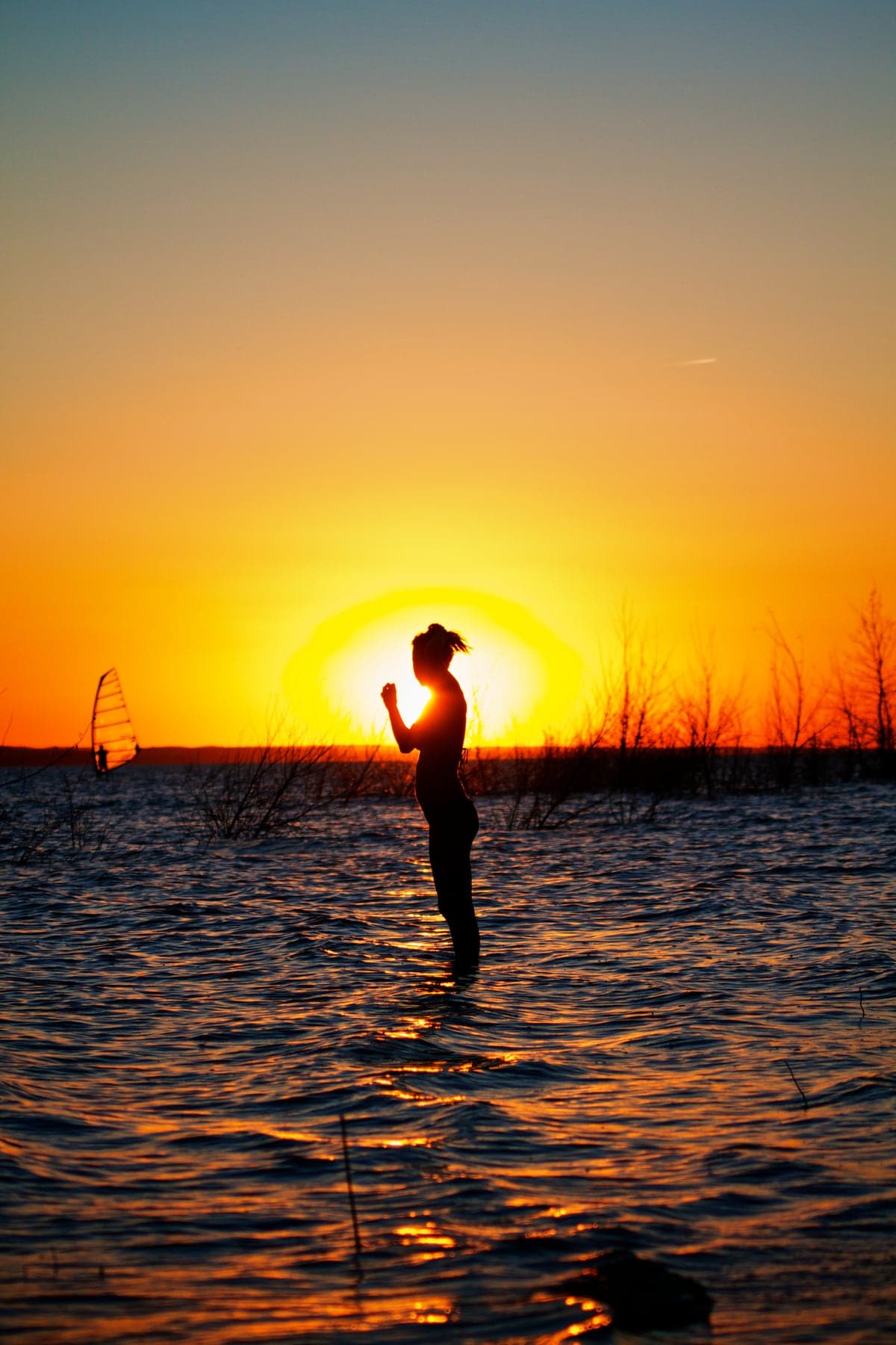 A person silhouetted against a vivid sunset at Lake McConaughy.