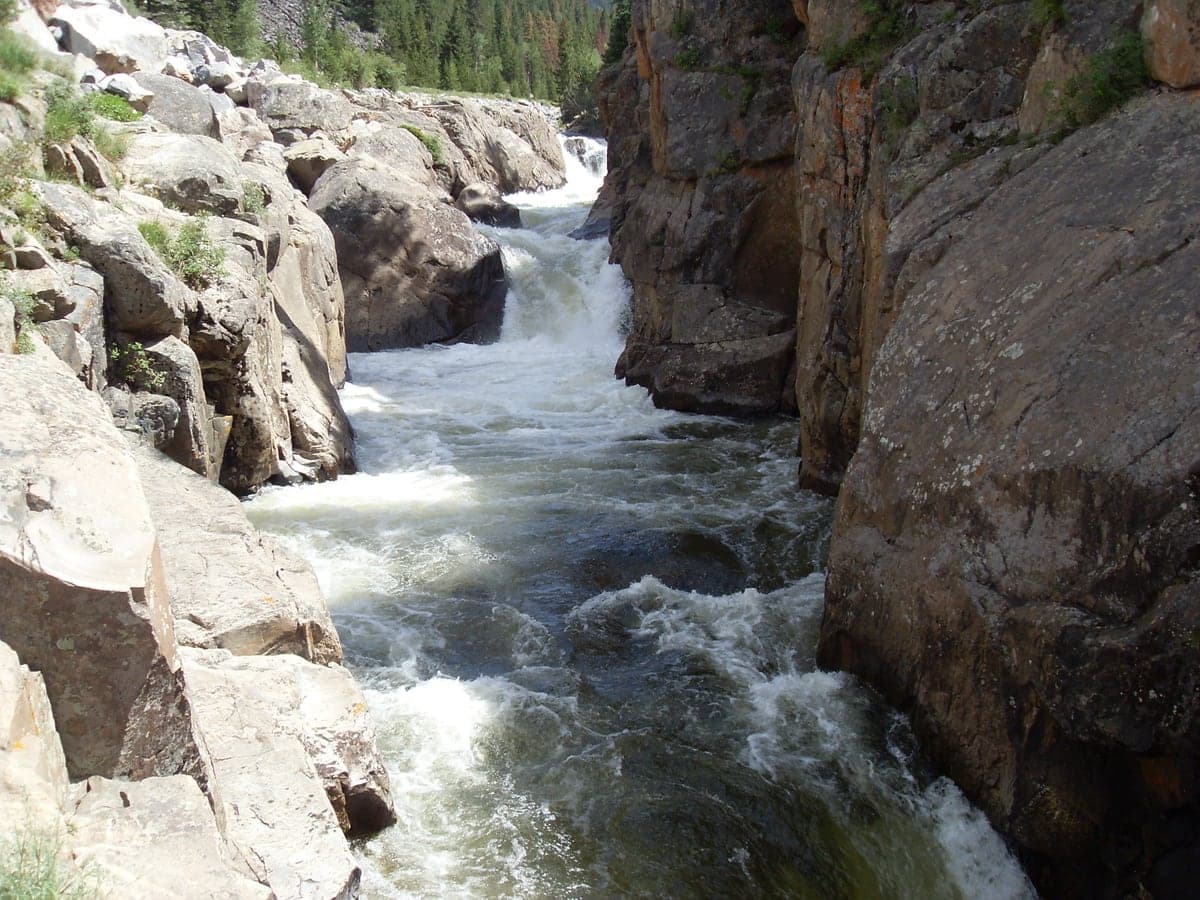 Poudre Falls rushing between granite walls in Poudre Canyon