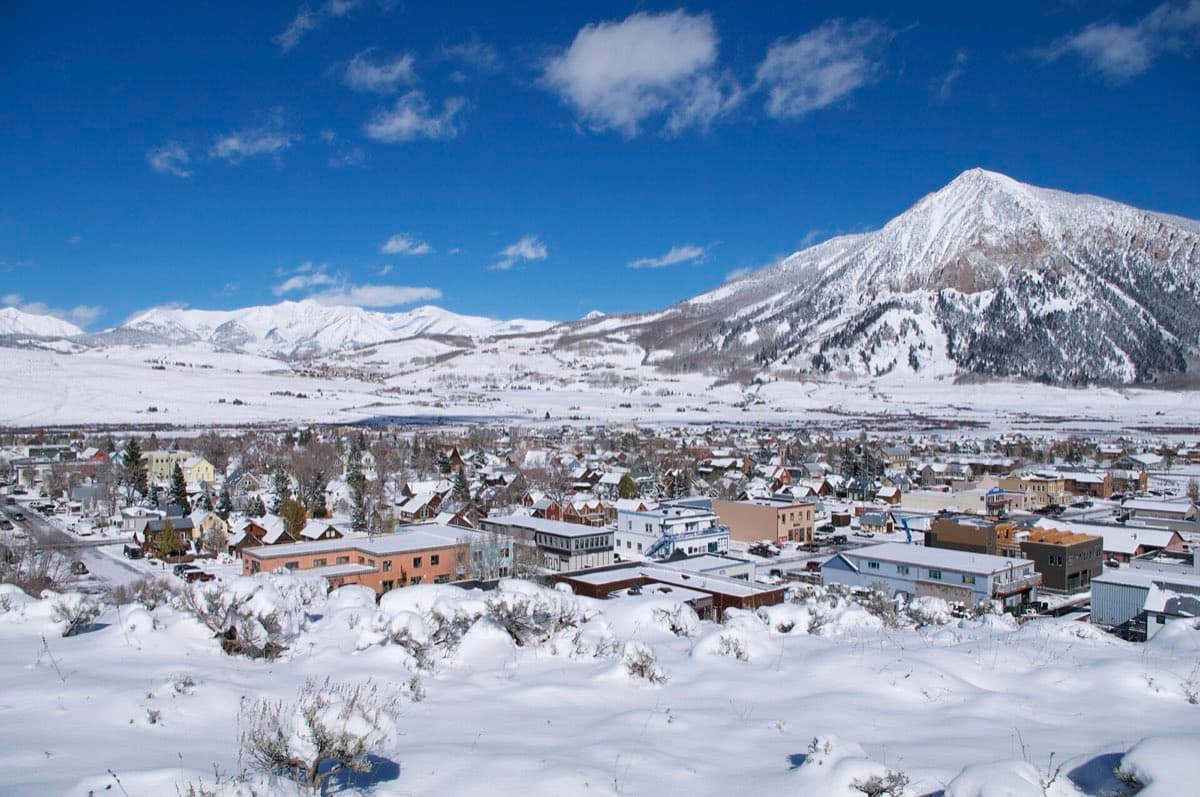 The town of Crested Butte beneath the rounded summit of Mount Crested Butte.