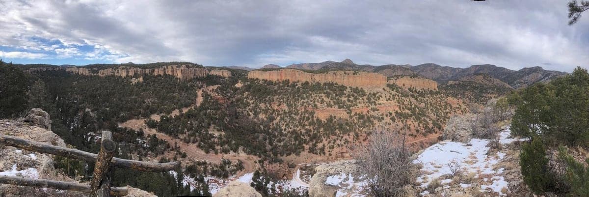 Long limestone cliff bands and the rough access road below The Bank Campground at Shelf Road