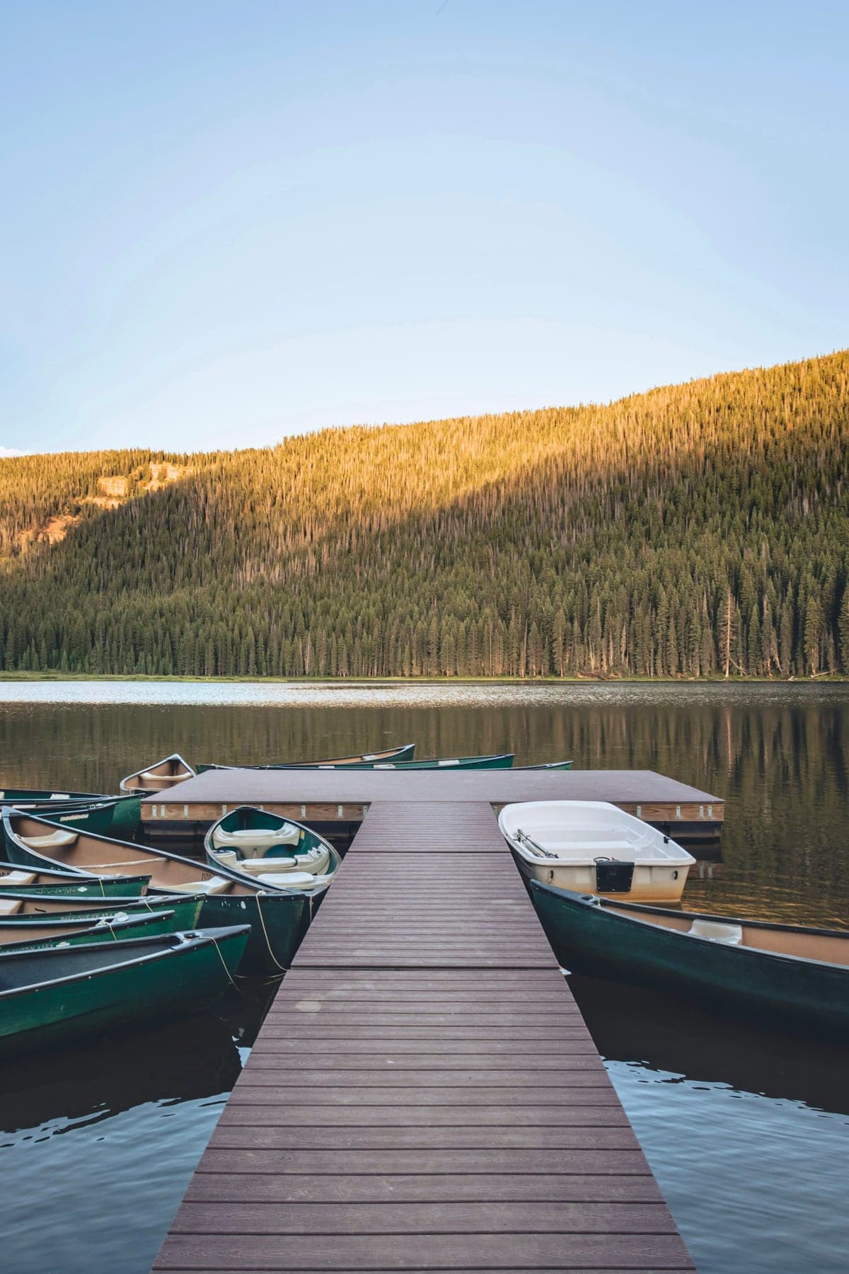 Wooden dock extending into Piney Lake beneath the Gore Range