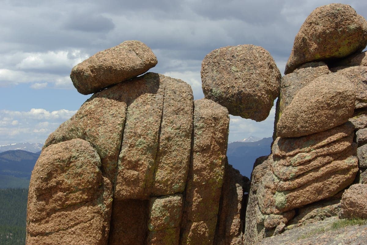 Large weathered granite boulders stand among trees in Lost Creek Wilderness.
