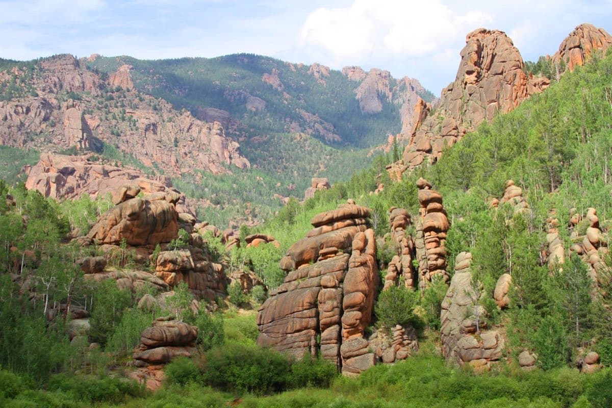 Granite formations rising above the forest in Lost Creek Wilderness.