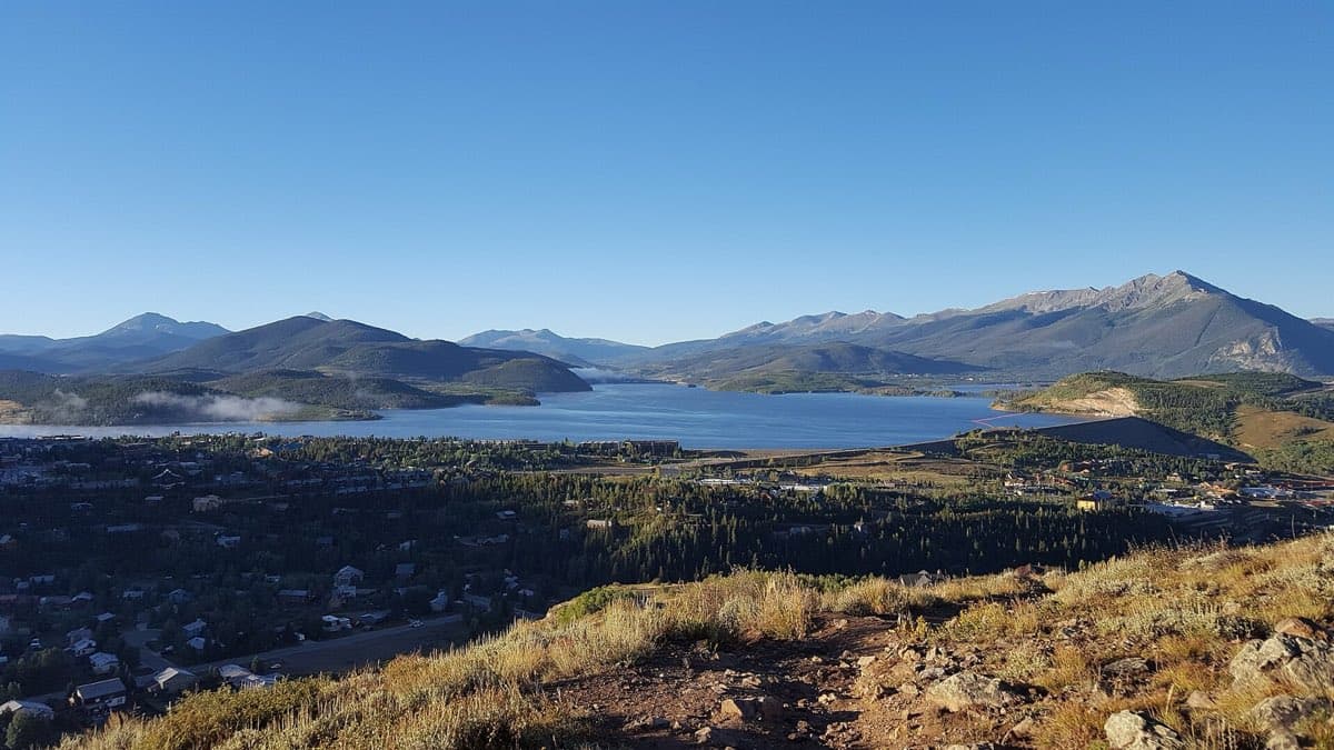 Dillon Reservoir surrounded by forested Summit County mountains.