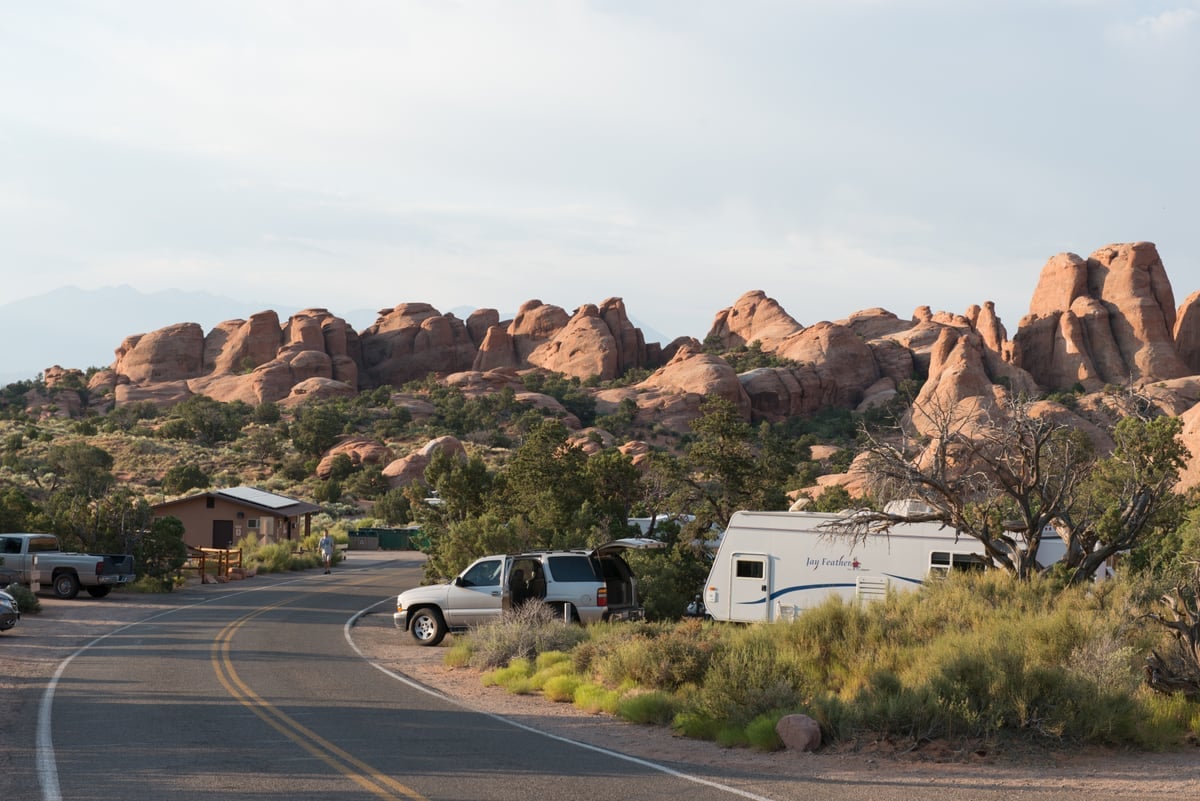 Campsites and RVs at Devils Garden Campground beneath sandstone fins in Arches National Park