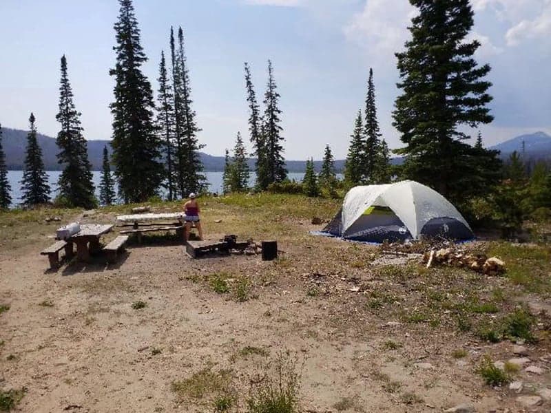 Tent, picnic table, and fire ring at Big Creek Lakes Campground site 2 beside the lake