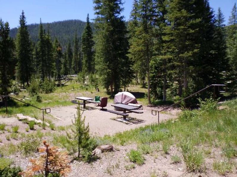 Tent, two picnic tables, and fire rings at site 23 in Hahns Peak Lake Campground