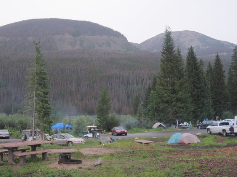 Tents and campsites below mountain slopes at Timber Creek Campground