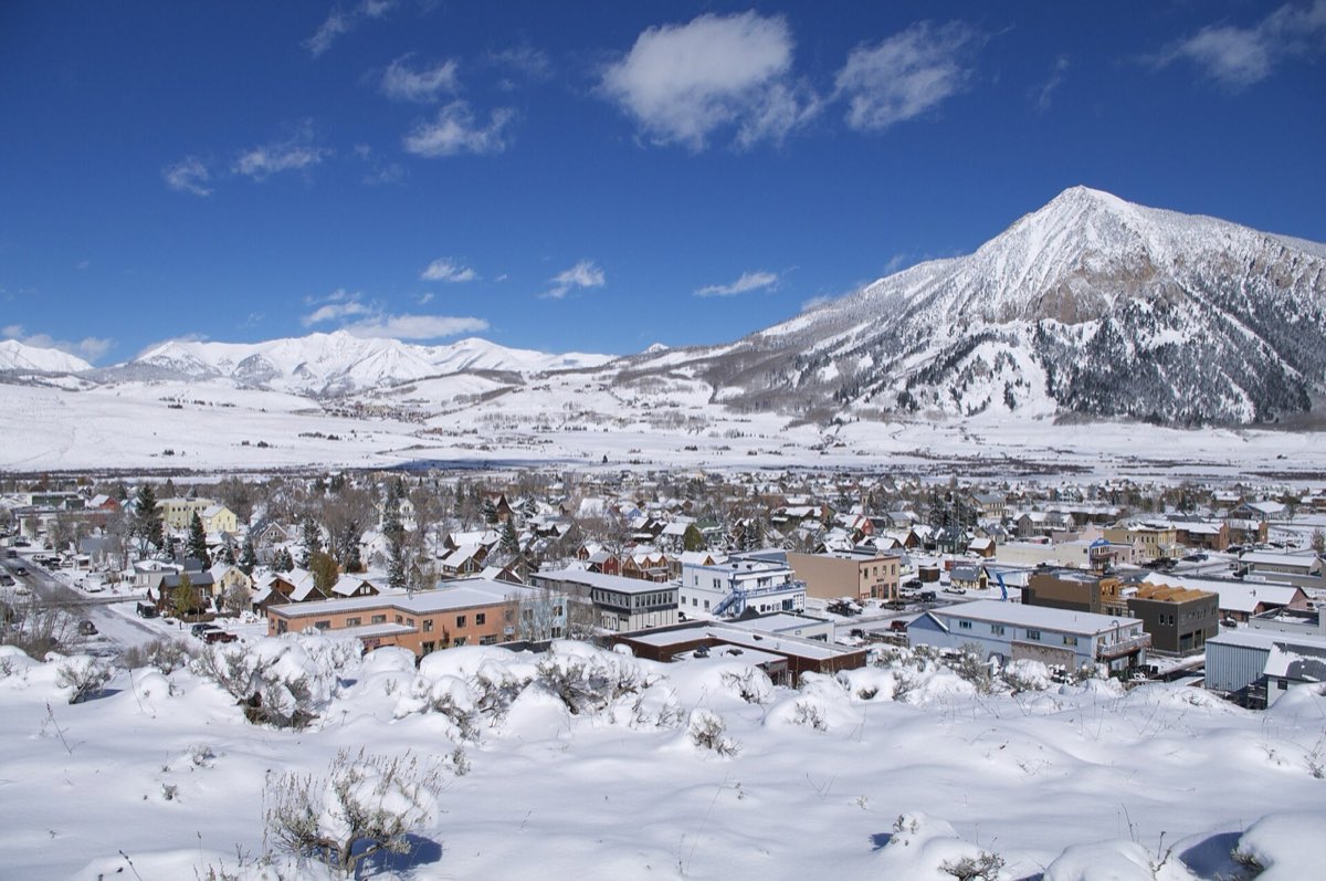 The town of Crested Butte beneath the rounded summit of Mount Crested Butte.
