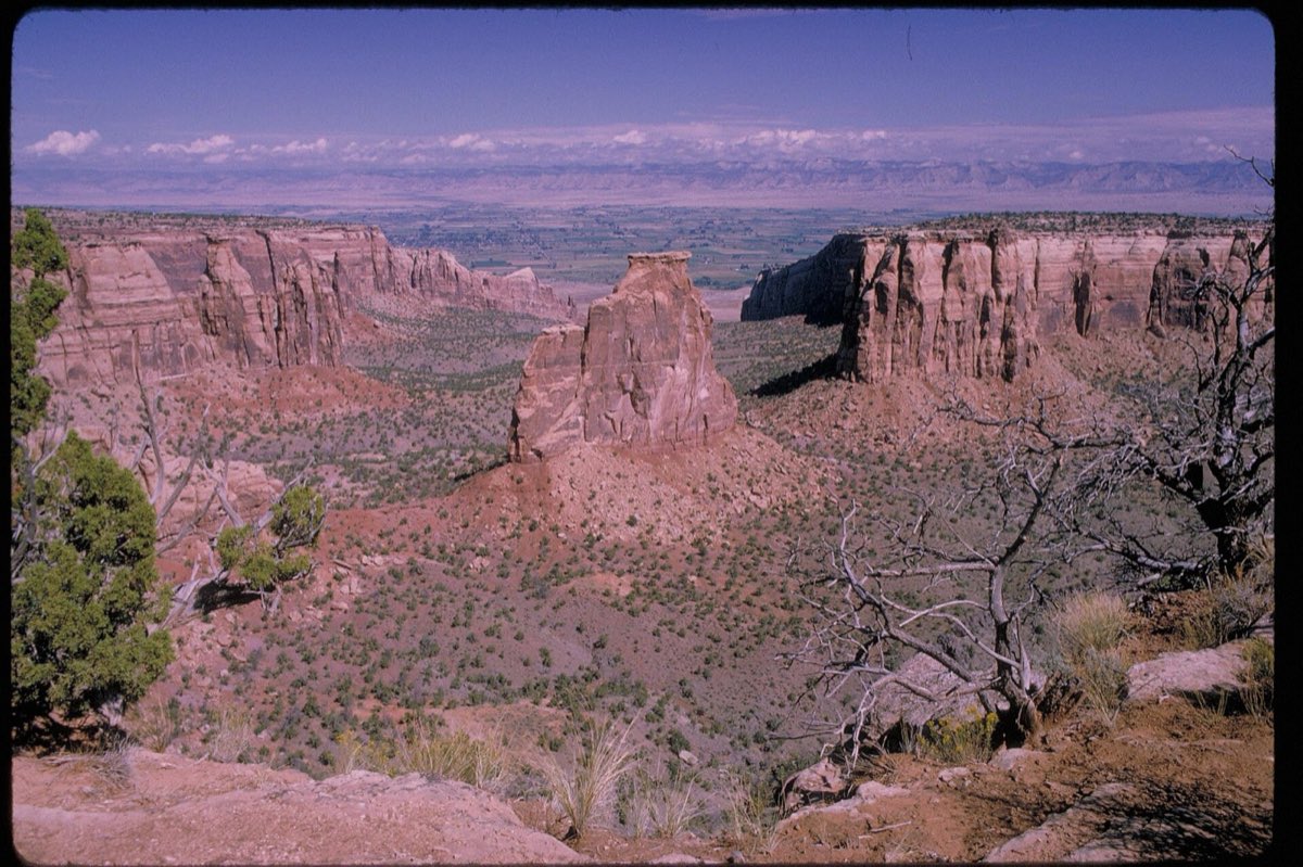 Red sandstone monoliths and layered canyons fill Colorado National Monument.