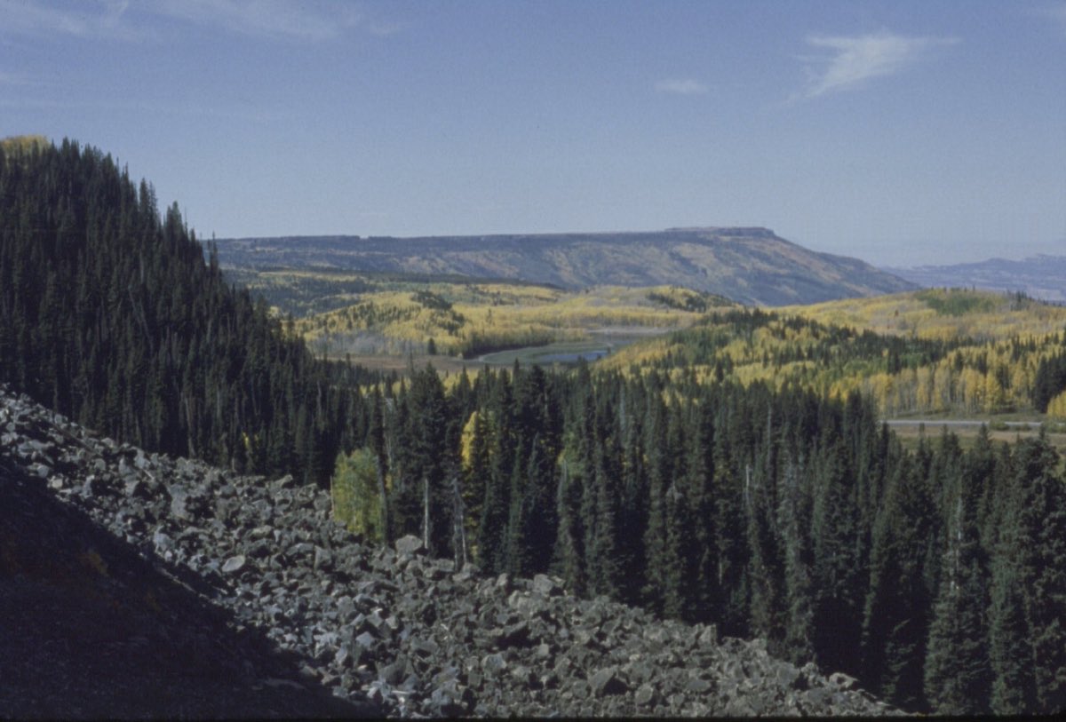 Forest and small mountain lakes spread below the high rim of Grand Mesa.