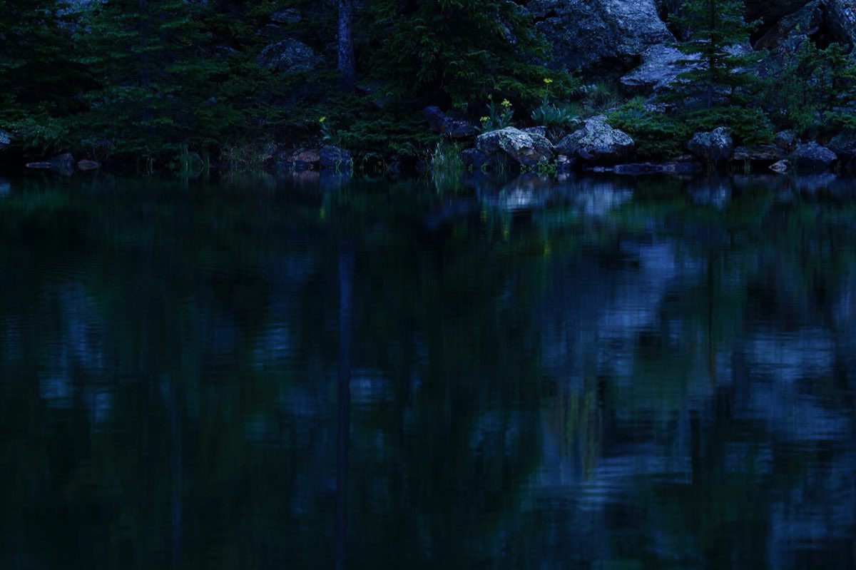 An alpine lake beneath the ridges of Guanella Pass.