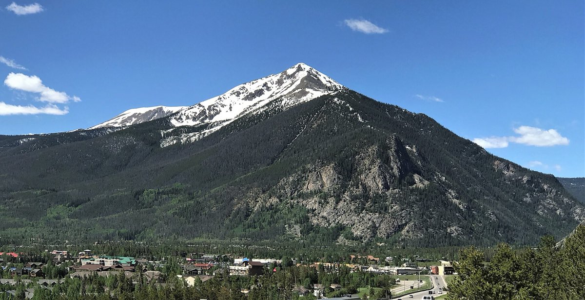 Snow-striped Peak One rising above the forested town of Frisco in June.