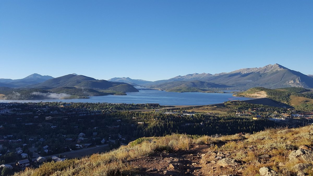 Dillon Reservoir surrounded by forested Summit County mountains.